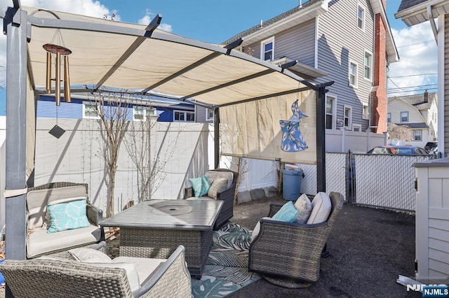 view of patio featuring fence and an outdoor hangout area