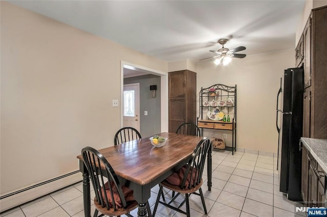 dining space with light tile patterned floors, baseboards, a baseboard heating unit, and a ceiling fan