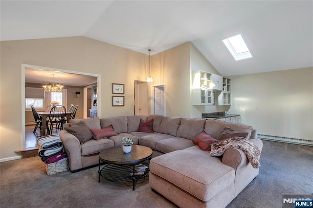 carpeted living room featuring a baseboard heating unit, lofted ceiling with skylight, and a notable chandelier