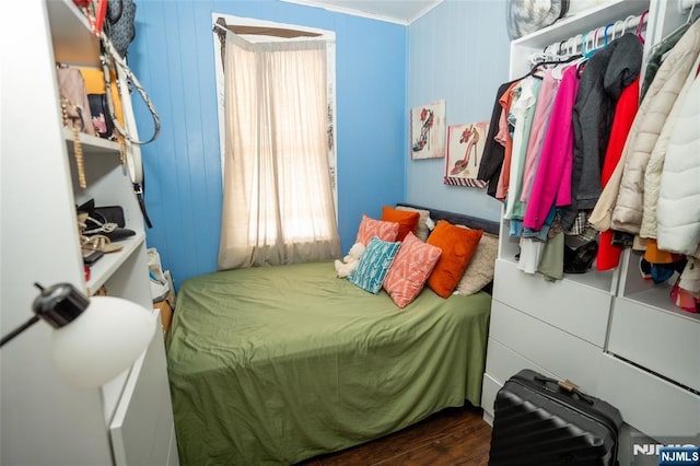 bedroom featuring crown molding and wood finished floors