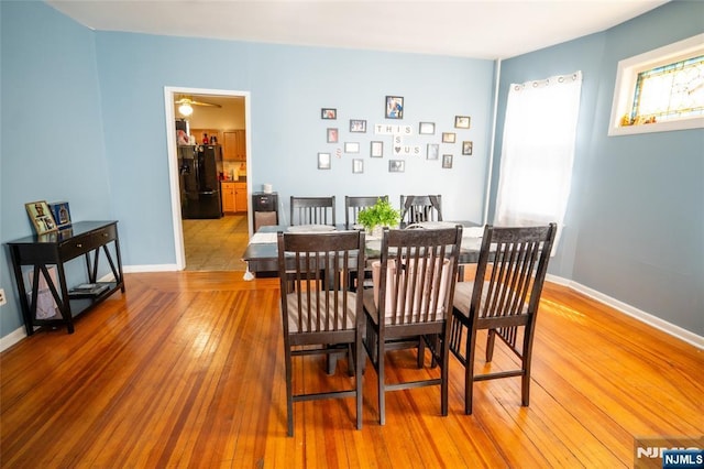 dining area with light wood-style floors and baseboards