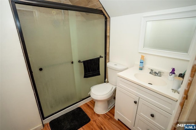 full bathroom with vanity, a stall shower, wood finished floors, and toilet