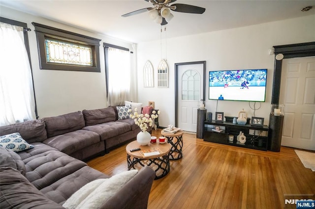 living room with a ceiling fan and wood finished floors