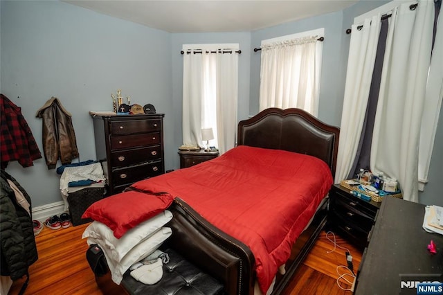 bedroom featuring baseboards and wood finished floors