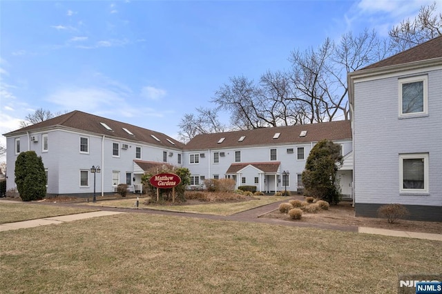 rear view of house featuring a yard