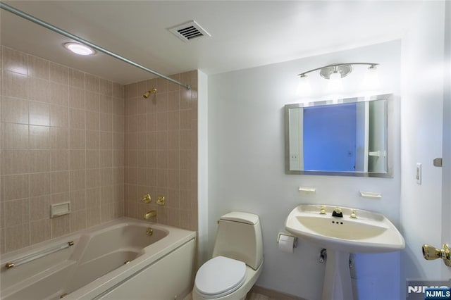 bathroom with toilet and shower / bath combination