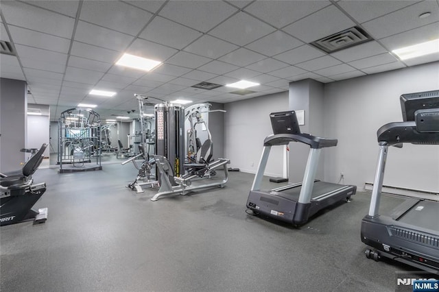exercise room with a paneled ceiling