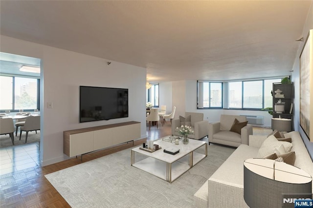 living area with plenty of natural light, an AC wall unit, and baseboards