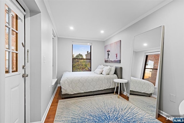 bedroom featuring ornamental molding, recessed lighting, wood finished floors, and baseboards