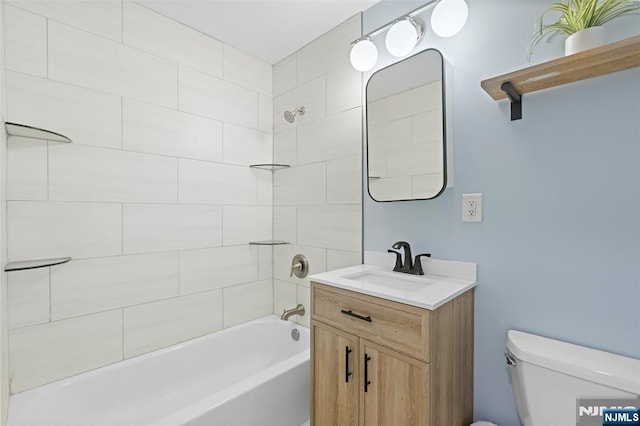 bathroom with vanity, shower / tub combination, and toilet