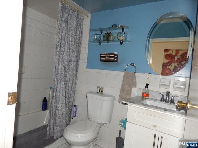 full bath with vanity, tile walls, toilet, and shower / tub combo with curtain