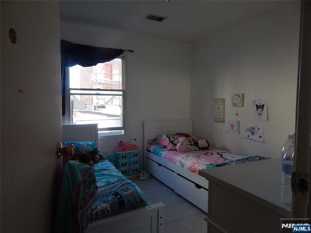 bedroom with visible vents and light tile patterned flooring