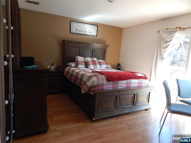 bedroom featuring visible vents and light wood-type flooring