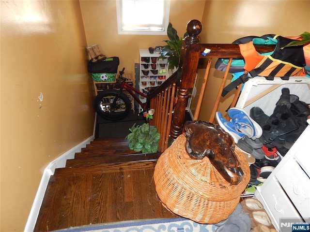 stairs featuring baseboards and wood finished floors