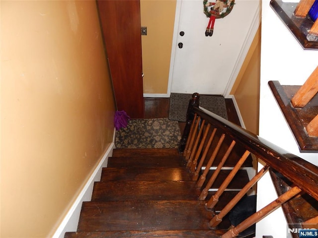 staircase featuring wood finished floors