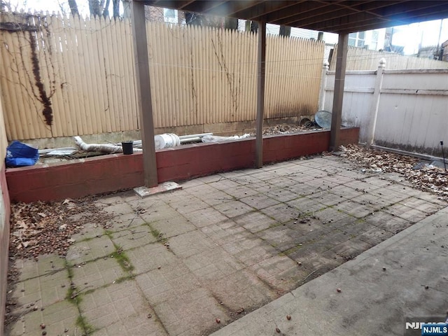 view of patio featuring fence