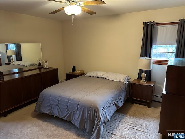 bedroom featuring carpet, a baseboard radiator, and a ceiling fan