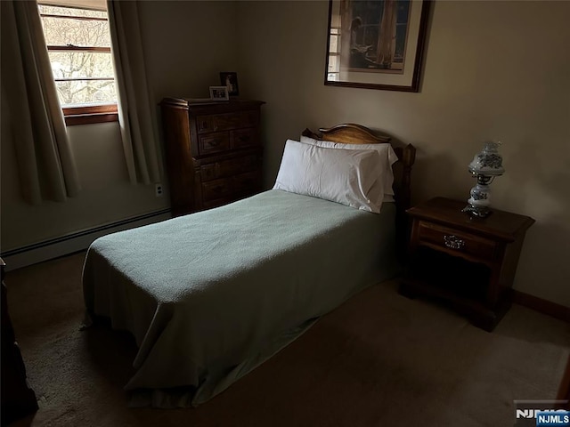 bedroom with a baseboard heating unit and carpet floors