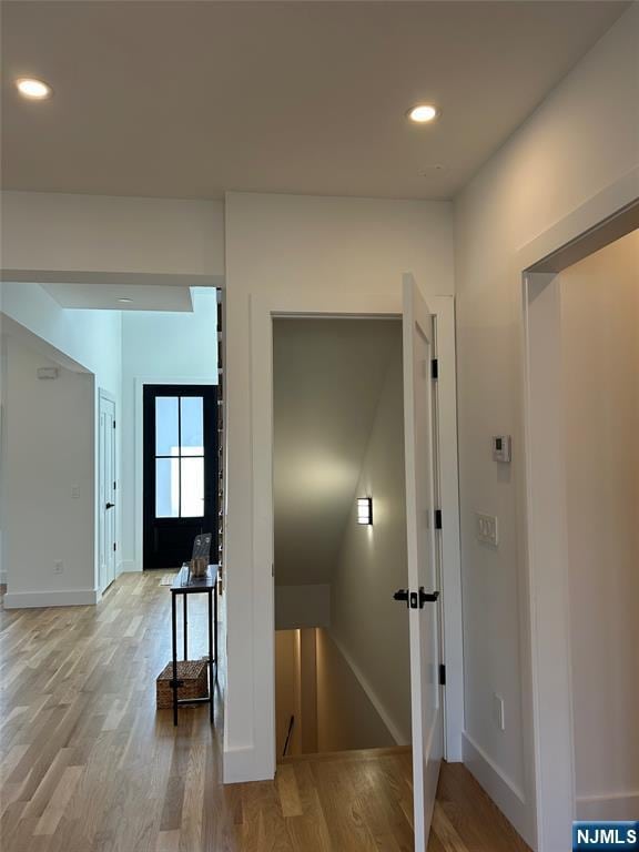 corridor featuring recessed lighting, baseboards, and wood finished floors