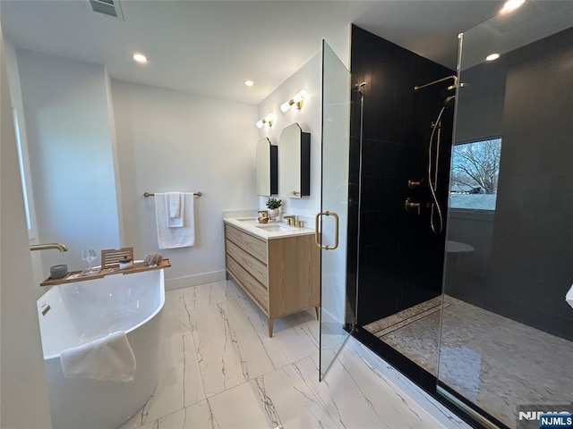 bathroom with baseboards, a freestanding bath, tiled shower, marble finish floor, and vanity