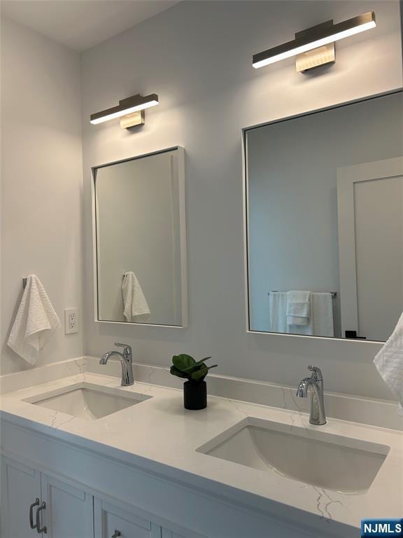 full bath featuring a sink and double vanity