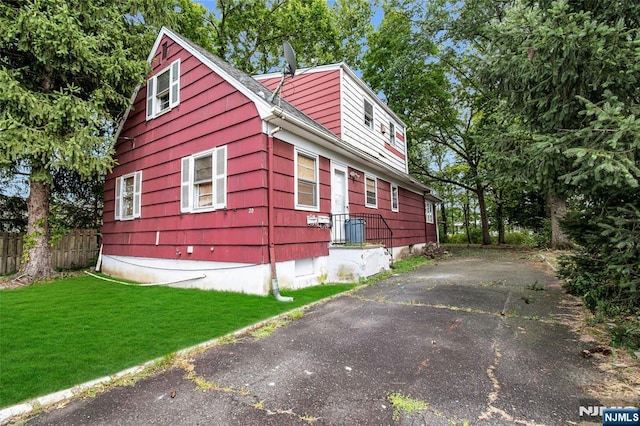 view of side of property with a yard and fence