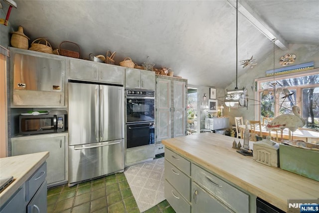 kitchen with vaulted ceiling with beams, black appliances, plenty of natural light, and wooden counters