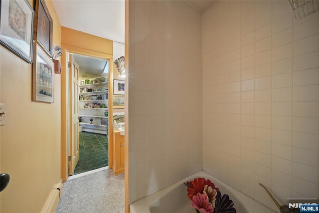 full bathroom featuring a tub to relax in and baseboards