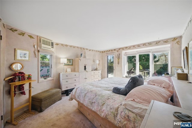 bedroom featuring access to outside, a wall mounted air conditioner, and light carpet