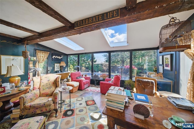 living area featuring lofted ceiling with skylight