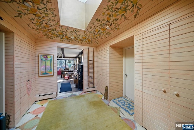 interior space featuring a baseboard heating unit and a skylight