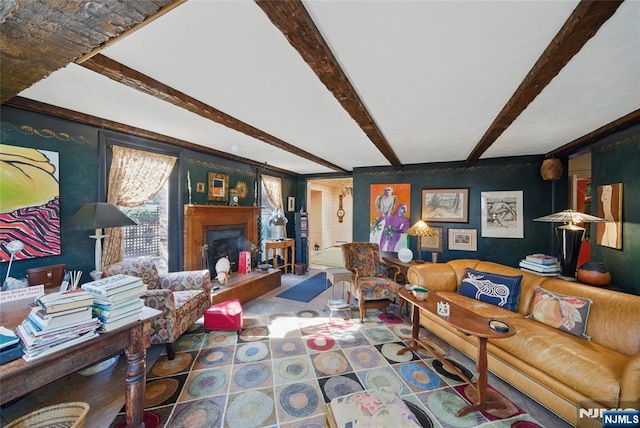 living room featuring a fireplace with raised hearth and beam ceiling