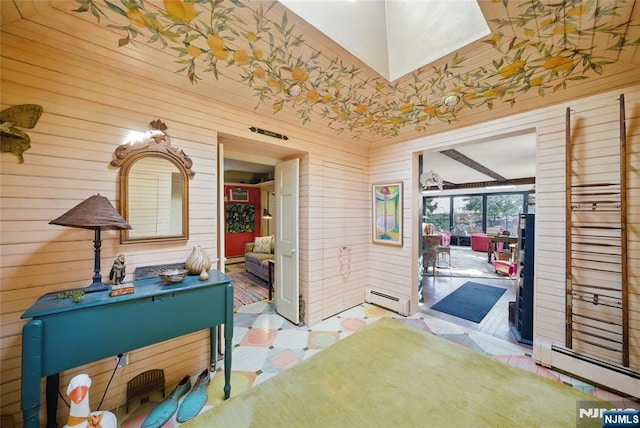 interior space featuring a sunroom, a baseboard heating unit, and tile patterned floors