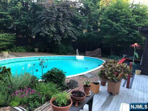 outdoor pool featuring a wooden deck