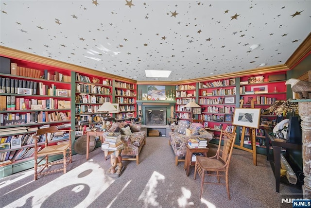 living area featuring carpet floors, bookshelves, and crown molding