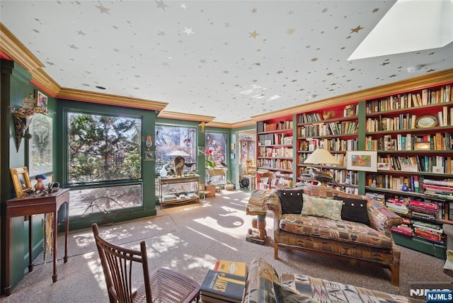 sitting room with wall of books, carpet, and crown molding