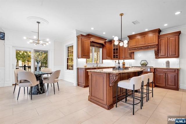 kitchen with brown cabinets, a notable chandelier, and a decorative wall