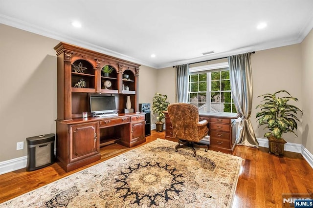 office featuring visible vents, crown molding, and wood finished floors