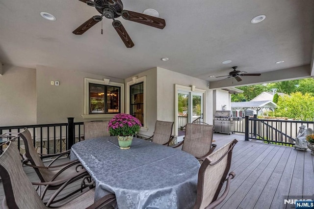 deck featuring a ceiling fan and outdoor dining space