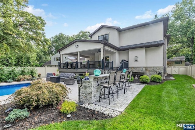 back of house with a patio area, a fenced backyard, a yard, and an outdoor hangout area