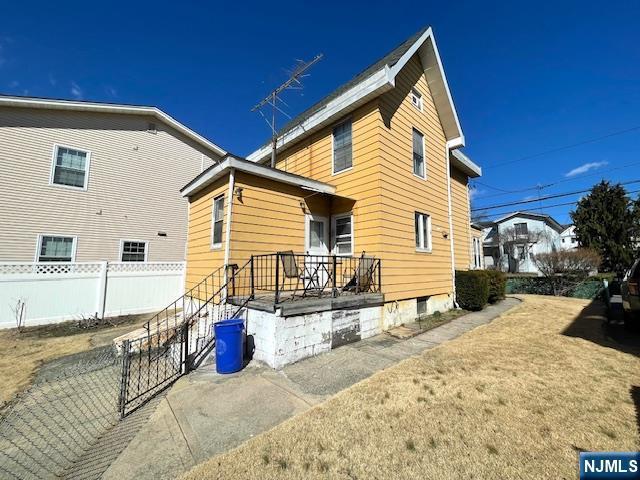 rear view of property with fence