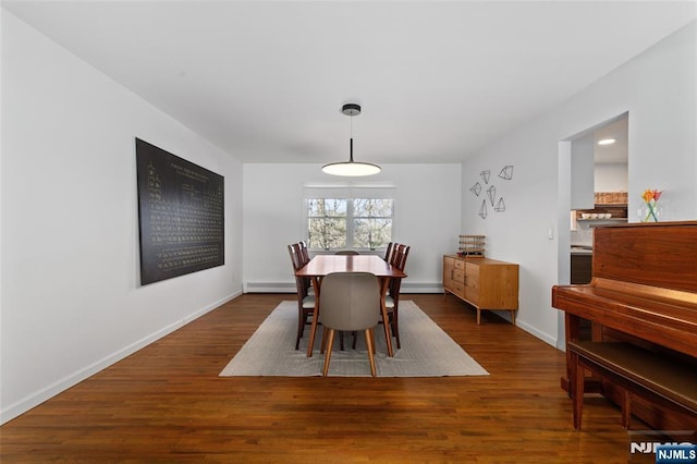 dining room with baseboard heating, baseboards, and wood finished floors