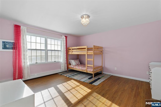 bedroom featuring baseboards and wood finished floors