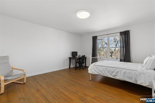 bedroom featuring hardwood / wood-style floors and baseboards