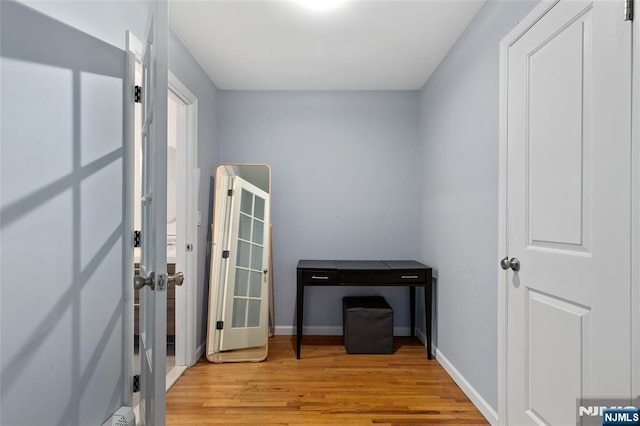 misc room with wood finished floors and baseboards