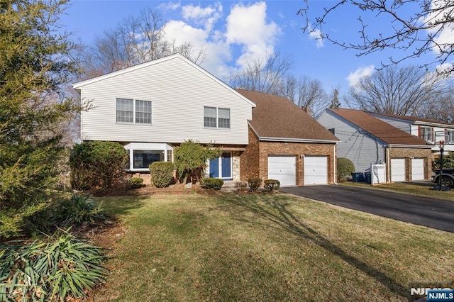 view of front of house featuring a front lawn, driveway, a shingled roof, a garage, and brick siding