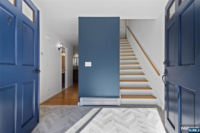 entrance foyer featuring stairway and baseboards