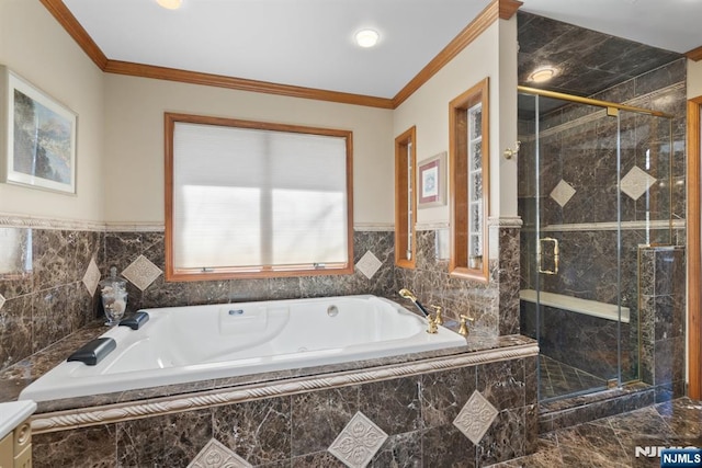 full bathroom with a shower stall, a bath, and crown molding