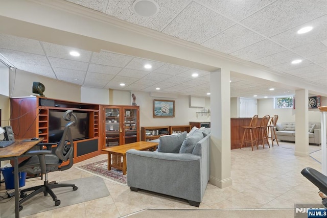 living room featuring recessed lighting, a paneled ceiling, indoor bar, and crown molding