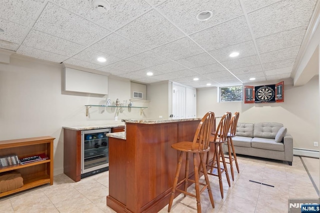 bar with beverage cooler, baseboards, visible vents, a baseboard radiator, and indoor wet bar